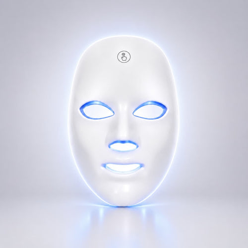 A white LED light therapy face mask with glowing blue and white light accents around the eye, nose, and mouth cutouts, shown on a clean light gray background.