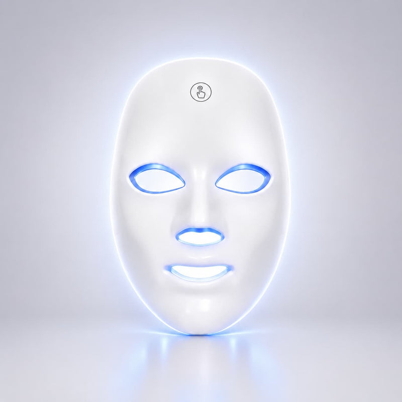 A white LED light therapy face mask with glowing blue and white light accents around the eye, nose, and mouth cutouts, shown on a clean light gray background.