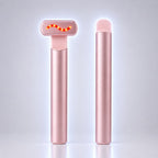 A pink metallic personal care device shown in two views on a clean light gray background: one T-shaped head with a glowing red wave graphic, and one slim cylindrical body.